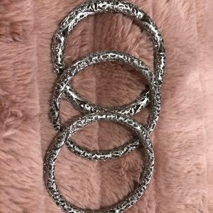 Silver Kendra Scott bangle bracelets.